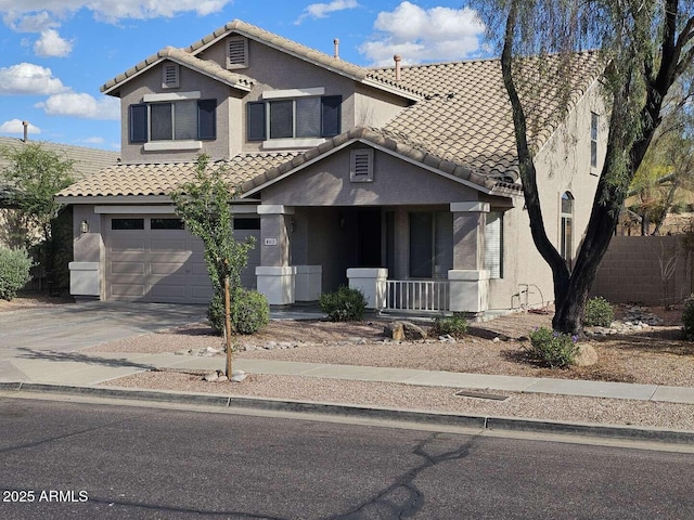 4613 W Fawn Dr, Laveen, AZ 85339 - traditional-style home featuring a porch, a tiled roof, a garage, and stucco siding
