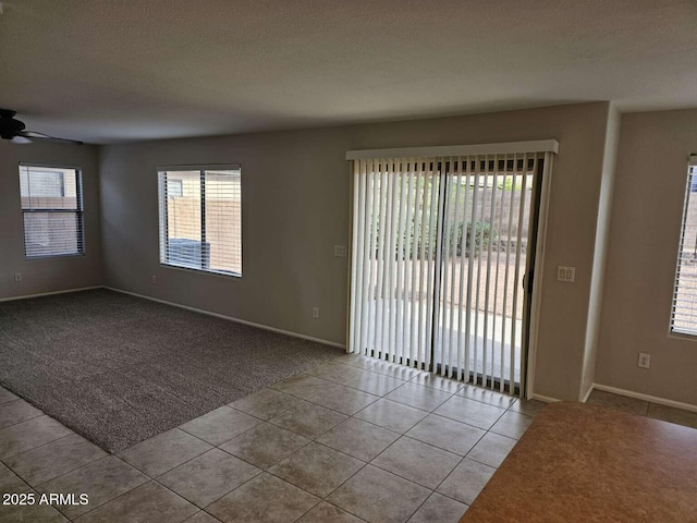 4613 W Fawn Dr, Laveen, AZ 85339 - carpeted empty room featuring a ceiling fan, baseboards, and tile patterned flooring