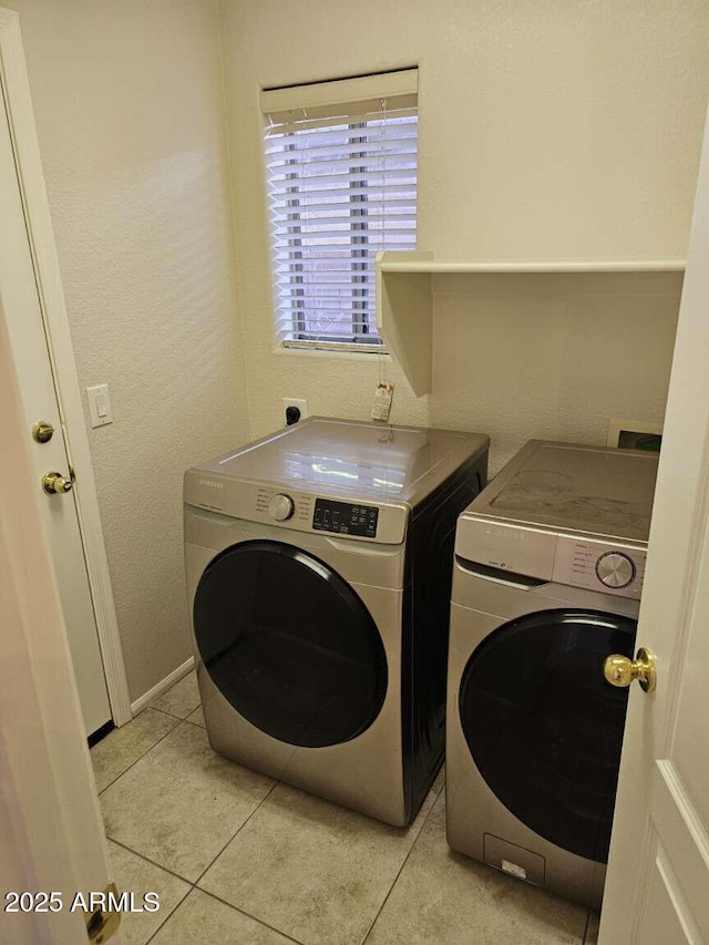 4613 W Fawn Dr, Laveen, AZ 85339 - clothes washing area with laundry area, baseboards, light tile patterned flooring, and washer and dryer
