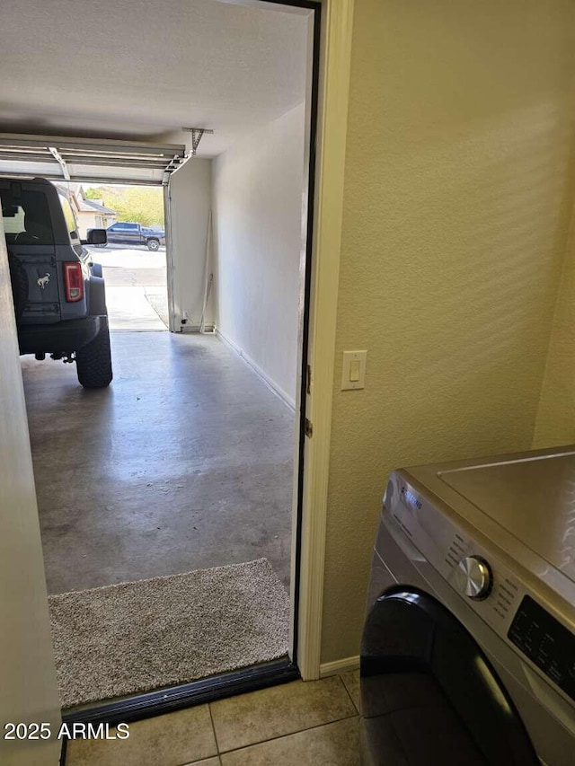 4613 W Fawn Dr, Laveen, AZ 85339 - laundry area with laundry area, washer / dryer, a textured wall, and baseboards