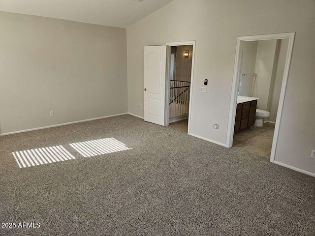 4613 W Fawn Dr, Laveen, AZ 85339 - unfurnished bedroom with carpet floors, baseboards, ensuite bathroom, and lofted ceiling