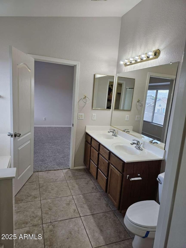 4613 W Fawn Dr, Laveen, AZ 85339 - full bath featuring double vanity, toilet, a sink, and tile patterned flooring