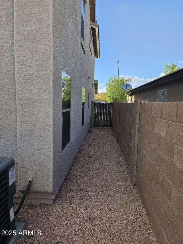 4613 W Fawn Dr, Laveen, AZ 85339 - view of home's exterior featuring stucco siding, fence, and cooling unit