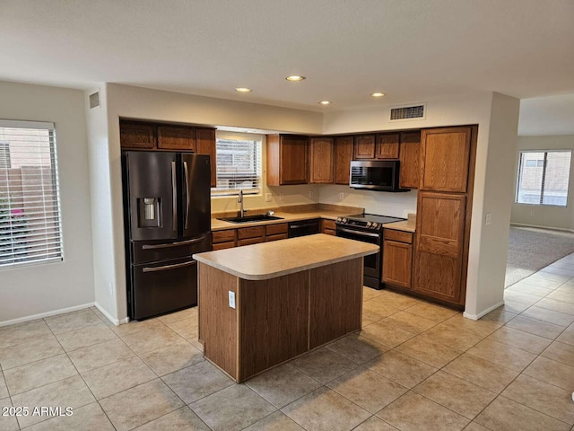 4613 W Fawn Dr, Laveen, AZ 85339 - kitchen with light countertops, light tile patterned flooring, a sink, and black appliances