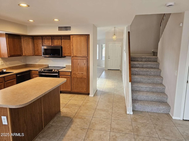 4613 W Fawn Dr, Laveen, AZ 85339 - kitchen with brown cabinetry, visible vents, appliances with stainless steel finishes, light tile patterned floors, and light countertops