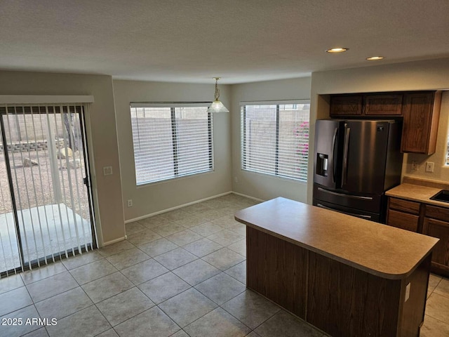 4613 W Fawn Dr, Laveen, AZ 85339 - kitchen with baseboards, a center island, light countertops, stainless steel fridge with ice dispenser, and light tile patterned floors
