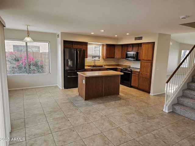 4613 W Fawn Dr, Laveen, AZ 85339 - kitchen with a sink, a center island, stainless steel microwave, fridge with ice dispenser, and electric stove