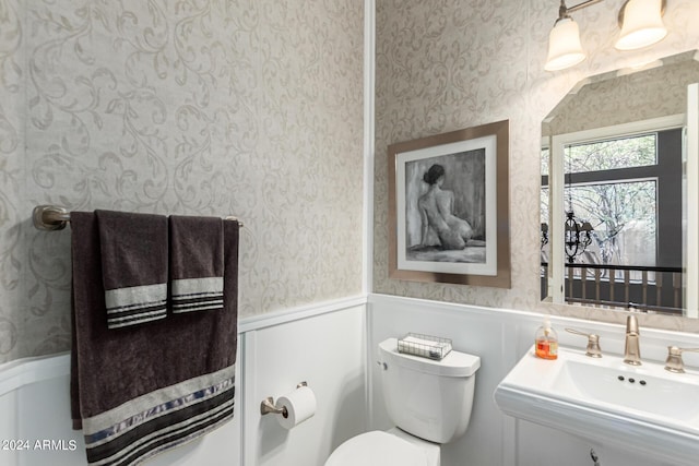 bathroom featuring toilet and sink