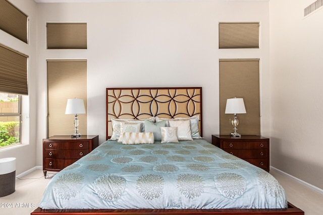 bedroom featuring light colored carpet