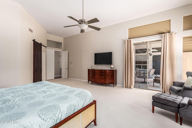 bedroom with ceiling fan, a barn door, light carpet, and access to outside