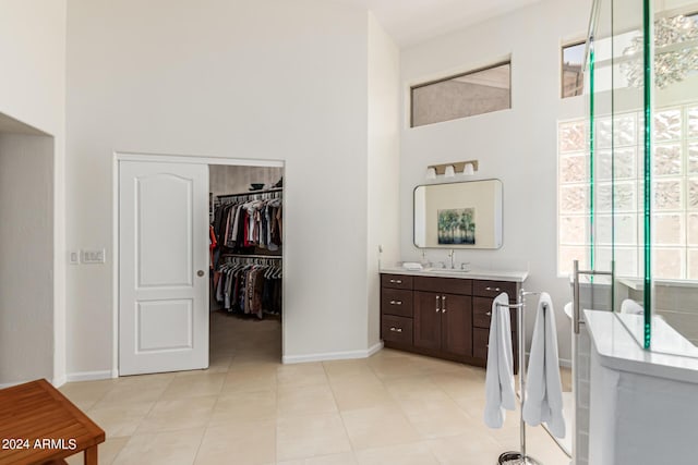 bathroom with tile patterned floors, plenty of natural light, and vanity