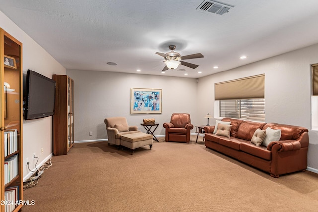 living room featuring light colored carpet and ceiling fan