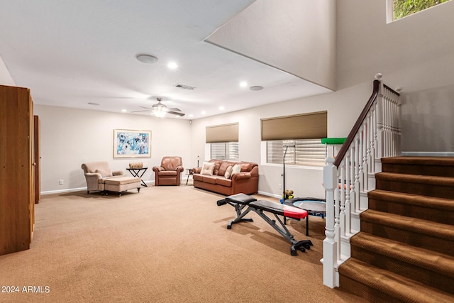 exercise area featuring ceiling fan and light colored carpet