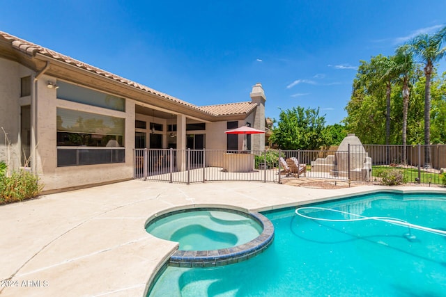 view of swimming pool with a patio area and an in ground hot tub