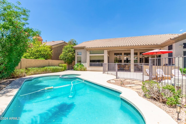 view of pool featuring an in ground hot tub and a patio area