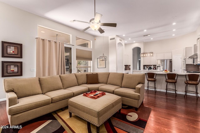 living room with dark hardwood / wood-style floors and ceiling fan