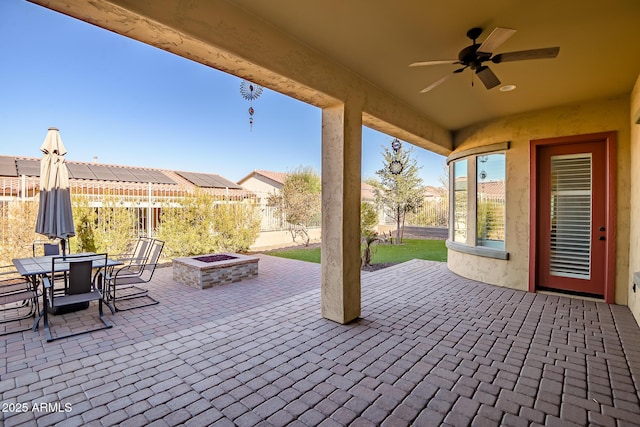 view of patio with ceiling fan and an outdoor fire pit