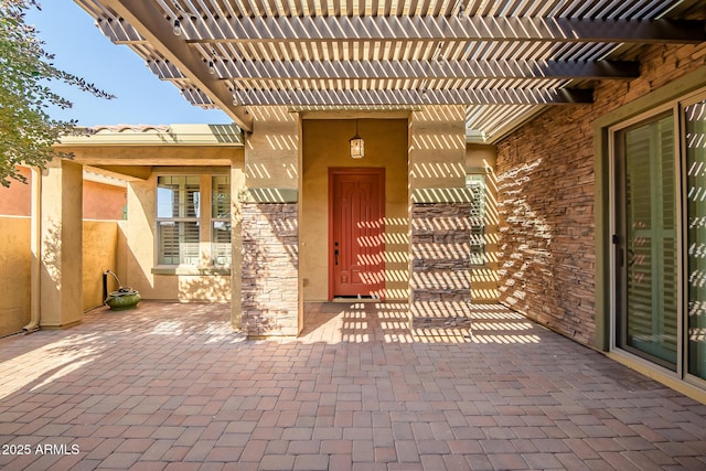 property entrance with a pergola