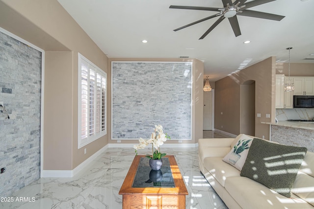 living area featuring baseboards, marble finish floor, plenty of natural light, and recessed lighting