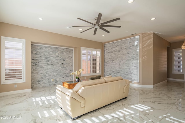 unfurnished living room with marble finish floor, baseboards, and recessed lighting