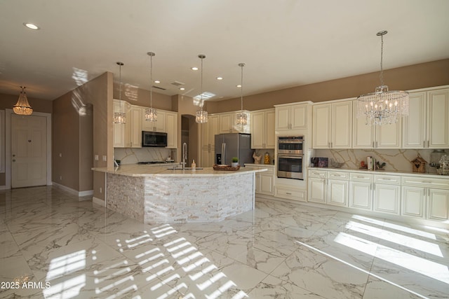 kitchen featuring recessed lighting, marble finish floor, appliances with stainless steel finishes, hanging light fixtures, and decorative backsplash