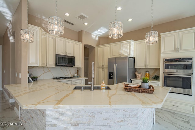 kitchen with visible vents, arched walkways, marble finish floor, stainless steel appliances, and backsplash