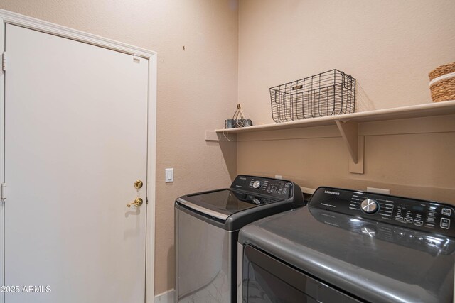 clothes washing area featuring laundry area and washing machine and dryer