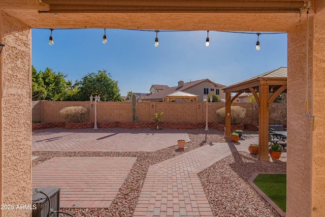 view of patio with a fenced backyard and a gazebo