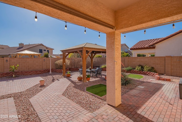 view of patio featuring a fenced backyard and a gazebo