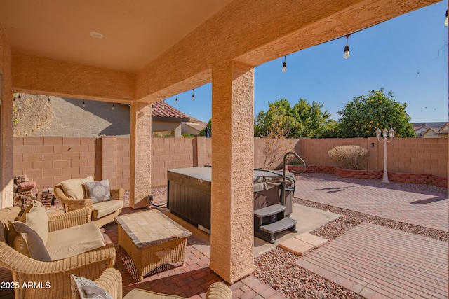 view of patio / terrace featuring a fenced backyard, outdoor lounge area, and a hot tub