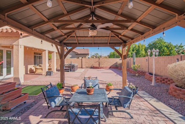 view of patio / terrace featuring outdoor dining space, a fenced backyard, and a gazebo