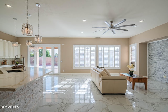 living room featuring recessed lighting, marble finish floor, and french doors