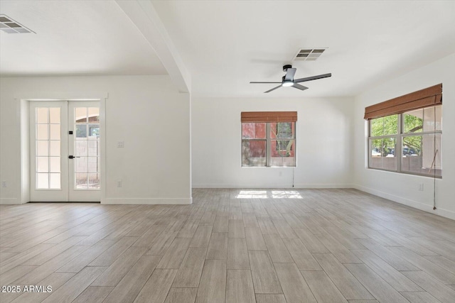 1510 W Fillmore St, Phoenix, AZ 85007 - unfurnished living room featuring light wood-type flooring, ceiling fan, french doors, and arched walkways