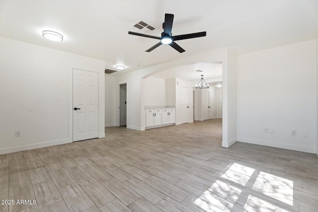 1510 W Fillmore St, Phoenix, AZ 85007 - unfurnished living room featuring arched walkways, ceiling fan, light wood-style floors, and a chandelier