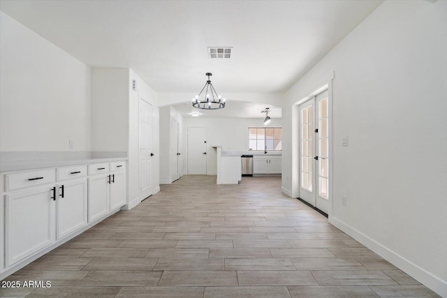 1510 W Fillmore St, Phoenix, AZ 85007 - unfurnished dining area featuring a chandelier, french doors, and light wood-style floors