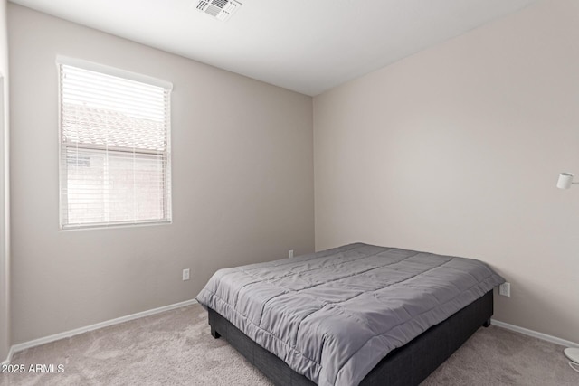 bedroom with baseboards, visible vents, and carpet