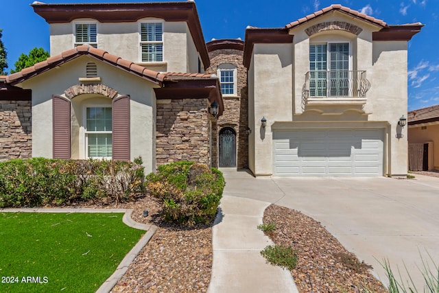 mediterranean / spanish-style home with a garage