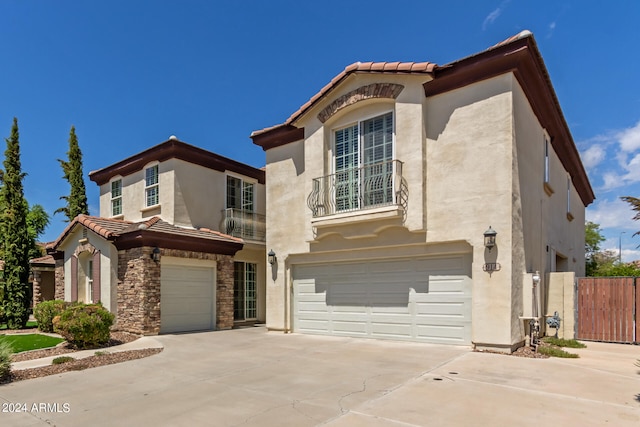 mediterranean / spanish-style home with a garage