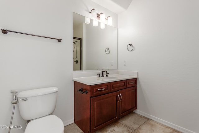 bathroom featuring tile patterned flooring, vanity, and toilet