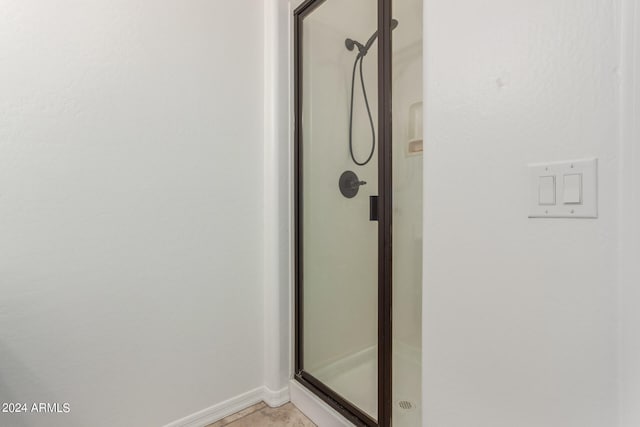 bathroom featuring a shower with door