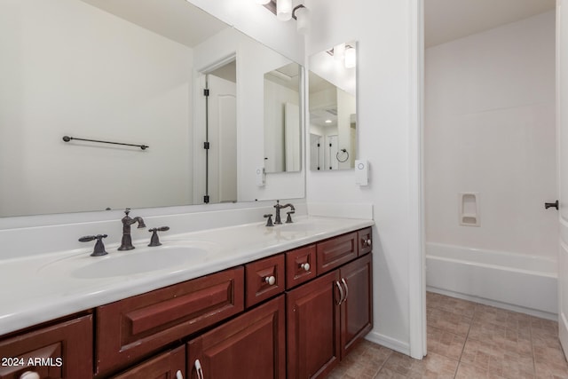 bathroom featuring vanity, tile patterned floors, and a tub