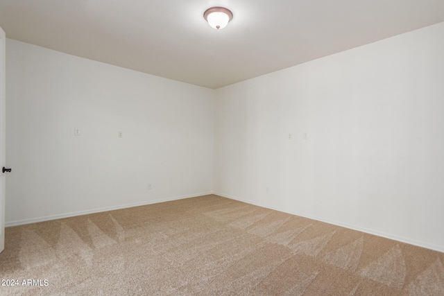 unfurnished room featuring light colored carpet