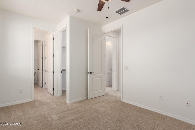 unfurnished bedroom featuring ceiling fan and light carpet