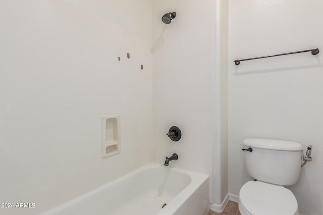 bathroom featuring toilet and  shower combination