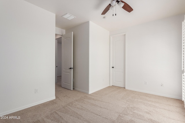 unfurnished bedroom with ceiling fan and light carpet