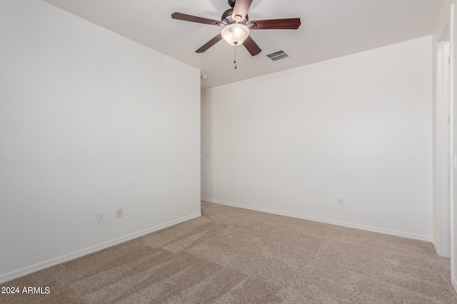 empty room with ceiling fan and light colored carpet