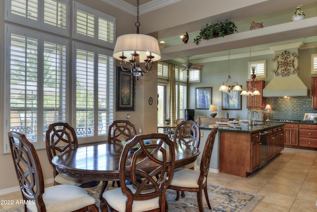 dining room featuring light tile patterned floors, ceiling fan with notable chandelier, crown molding, and sink