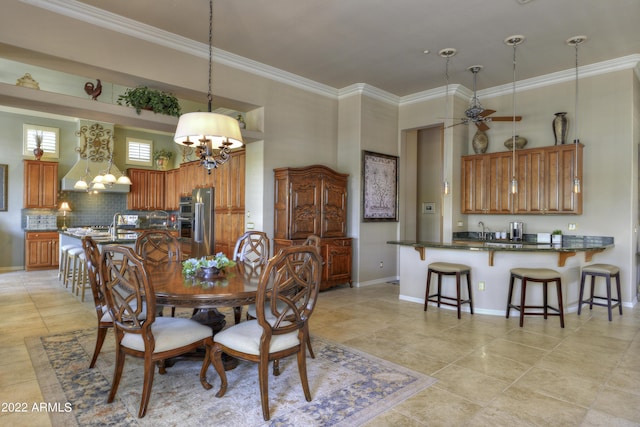 dining room featuring sink, light tile patterned floors, ceiling fan with notable chandelier, and ornamental molding