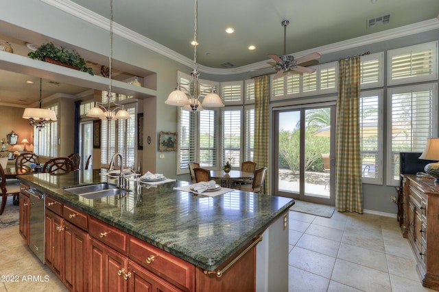 kitchen featuring a kitchen island with sink, ceiling fan with notable chandelier, sink, dark stone countertops, and light tile patterned floors