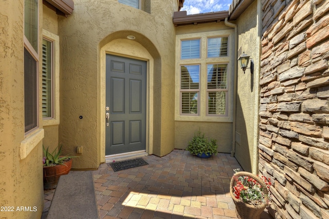 entrance to property with a patio area